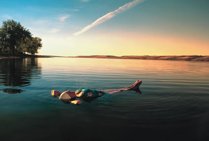 Lady floating in Lake Manitou