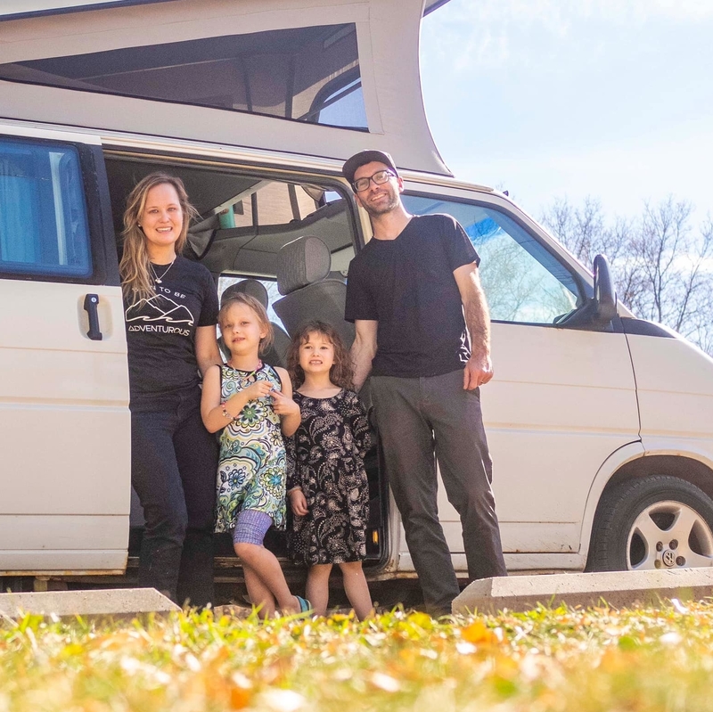 Annika, Cam and their two daughters in front of a white van