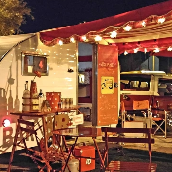 vintage RV with awning and lights