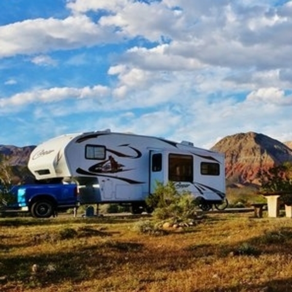 RV in Arizona with the mountains and sunny skies in background