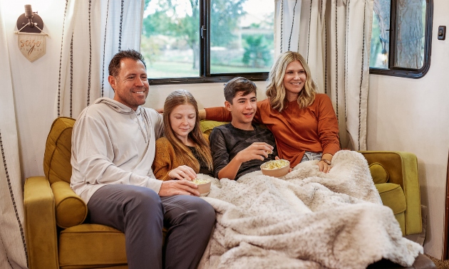 The Wanderpreneur family sitting together, including both parents and two children