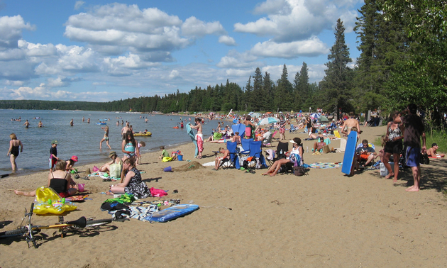 people gathered on a beach in Waskesiu Saskatchewan