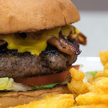 A loaded burger served with fries at John's Plate. 