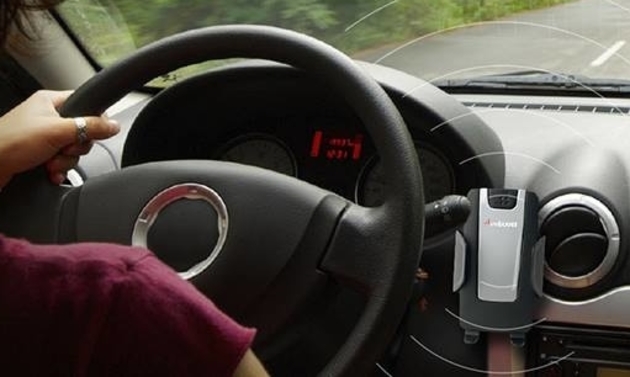 cellphone attached on the dashboard of a vehicle
