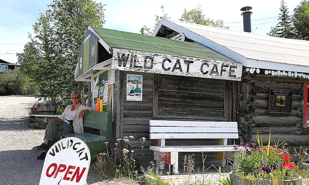 lady sitting on a bench in front of the Wildcat Cafe in Yellowknife, Northwest Territories