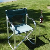 Backyard Butler Wine Bottle Holder next a lawn chair. 