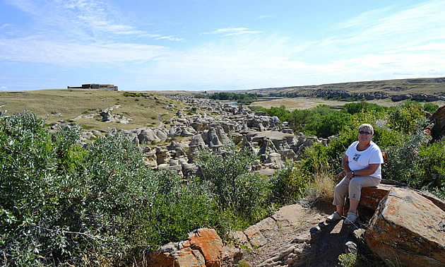 lady sitting on a rock at writing on stone provincial park